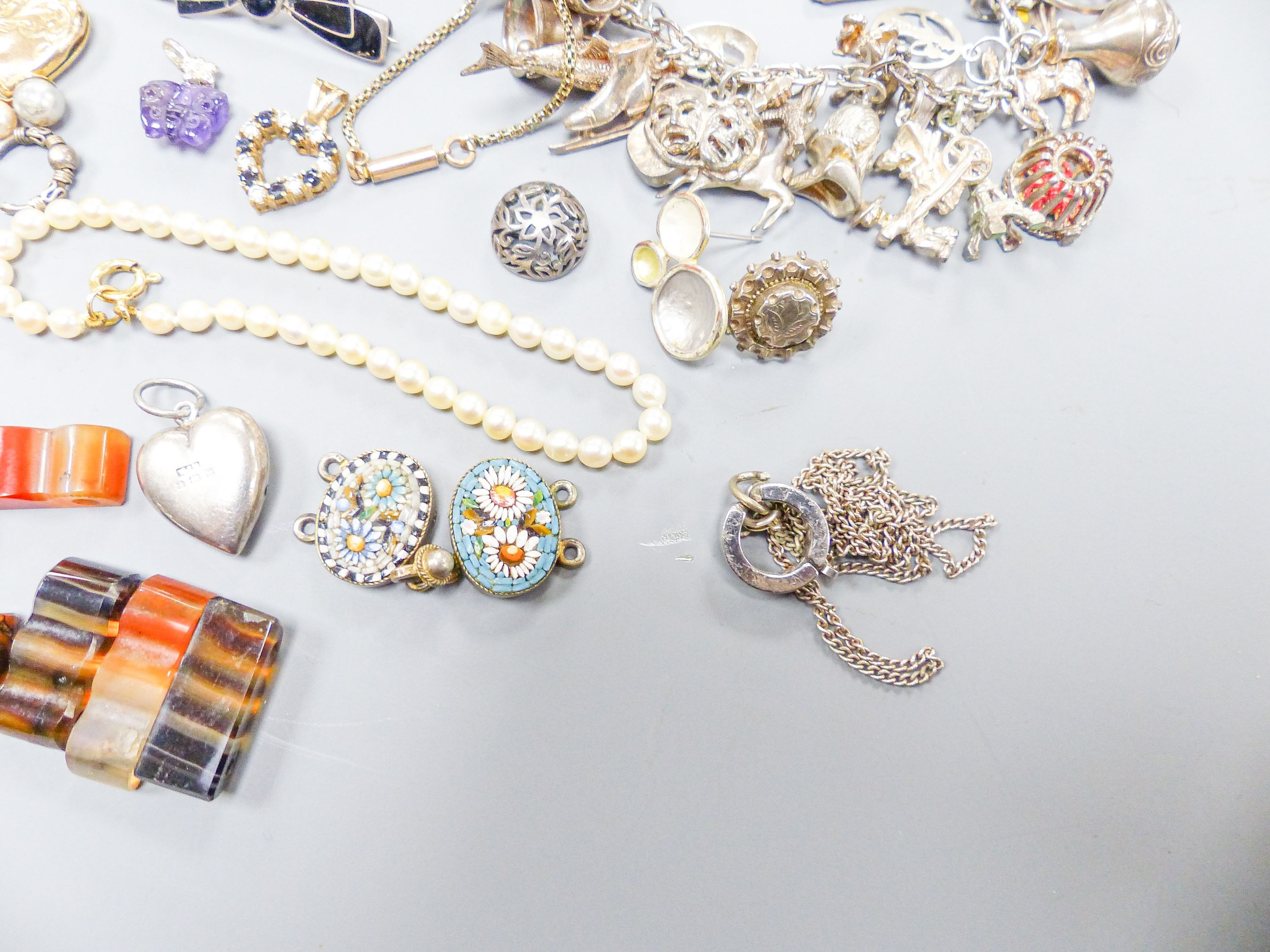 Assorted gold and silver jewellery including bar brooches, charm bracelet etc.